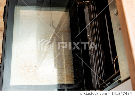 Oven with open dirty door smeared old dried grease, kitchen appliances equipment Oven with open dirty door smeared old dried grease, kitchen appliances equipment 141847484