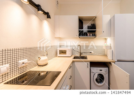 Style cozy minimalist light kitchen interior in small studio apartment room Style cozy minimalist light kitchen interior in small studio apartment room 141847494