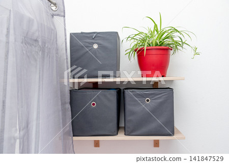 Gray square boxes for organizing space and storing things on shelf bedroom Gray square boxes for organizing space and storing things on shelf bedroom 141847529