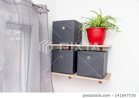 Gray square boxes for organizing space and storing things on shelf bedroom Gray square boxes for organizing space and storing things on shelf bedroom 141847530