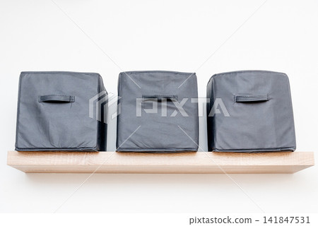Gray square boxes for organizing space and storing things on shelf bedroom Gray square boxes for organizing space and storing things on shelf bedroom 141847531