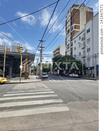 Cordoba, Argentina - April 9, 2026: Urban intersection with apartment buildings and traffic lights Cordoba, Argentina - April 9, 2026: Urban intersection with apartment buildings and traffic lights 141847571