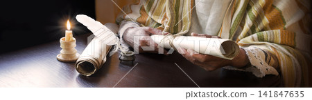 Man holding an old scroll Man holding an old scroll 141847635