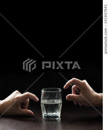 An optimist and a pessimist's opinion about a glass of water An optimist and a pessimist's opinion about a glass of water 141847641