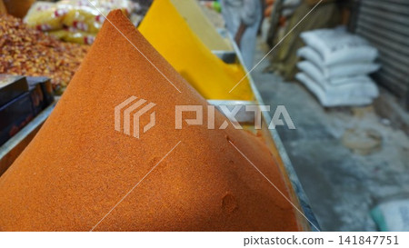 Heap of red chili powder displayed at a spice shop in a busy local market, culinary spice trading and sales concept Heap of red chili powder displayed at a spice shop in a busy local market, culinary spice trading and sales concept 141847751