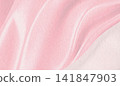 Pink textured paper background with gentle flowing waves, symbolizing hope and support for breast cancer awareness and women's health 141847903