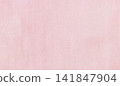 Pink paper background showing a subtle texture with visible cotton fibers, offering a clean surface for design, branding, and cosmetic product presentation 141847904