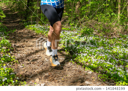 Close-up of a runners legs in white sneakers Close-up of a runners legs in white sneakers 141848199