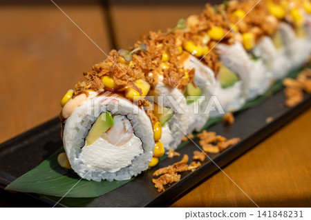 sushi roll with shrimp, avocado, corn, crispy onion and spicy sauce sushi roll with shrimp, avocado, corn, crispy onion and spicy sauce 141848231