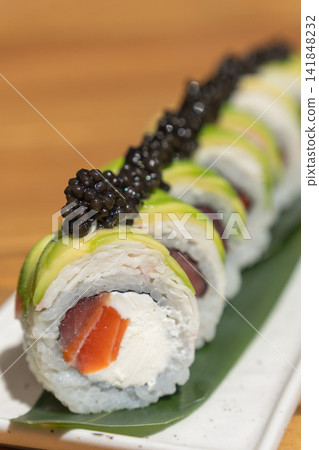 sushi roll with avocado, black caviar, salmon, cream cheese and rice sushi roll with avocado, black caviar, salmon, cream cheese and rice 141848232