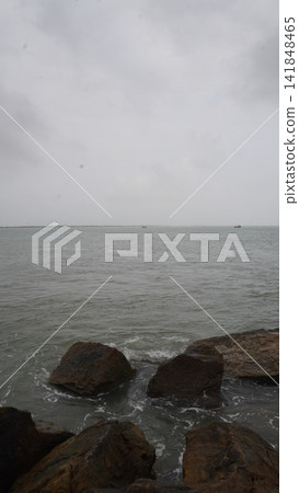Calm sea and dark rocks on the coast, atmospheric nature photography for travel and landscape , nature concept Calm sea and dark rocks on the coast, atmospheric nature photography for travel and landscape , nature concept 141848465