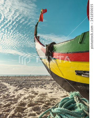 Traditional Portuguese fishing boat on sandy beach Traditional Portuguese fishing boat on sandy beach 141850035