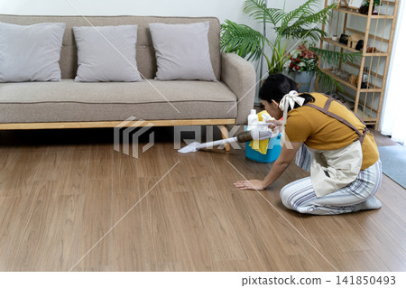 Asian adult woman vacuum hardwood floor daily clean routine living room home maintenance household chores domestic life Asian adult woman vacuum hardwood floor daily clean routine living room home maintenance household chores domestic life 141850493