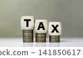 Tax increase concept. tax icon on coins. increasing taxes, Pay online income tax. income tax system icon around on wood floor background. 141850617