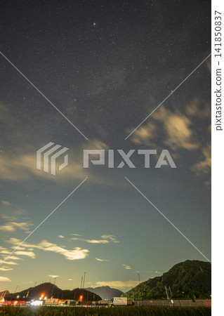 A beautiful summer starry sky floating above a sunflower field in Kasaoka City, Okayama Prefecture, Japan. A beautiful summer starry sky floating above a sunflower field in Kasaoka City, Okayama Prefecture, Japan. 141850837