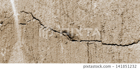 Cracked beige concrete wall texture background 141851232