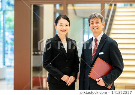 Smiling senior men and women standing in the lobby 141852837