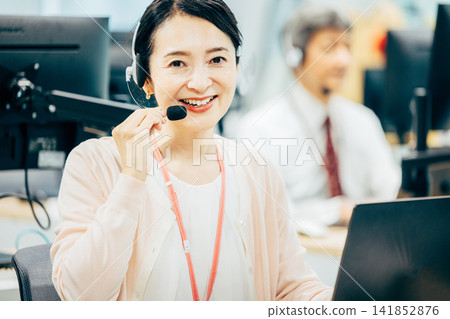 Female operator working in a call center Female operator working in a call center 141852876