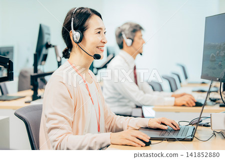 Female operator working in a call center Female operator working in a call center 141852880