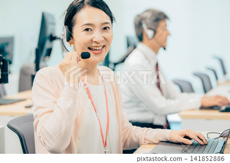 Female operator working in a call center Female operator working in a call center 141852886