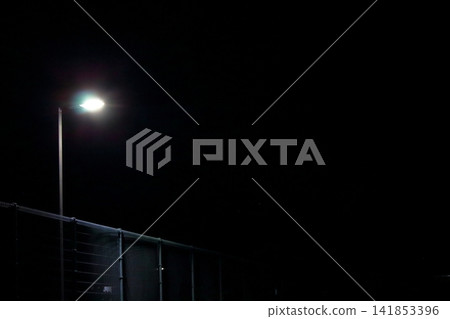 Streetlight shining at night 141853396