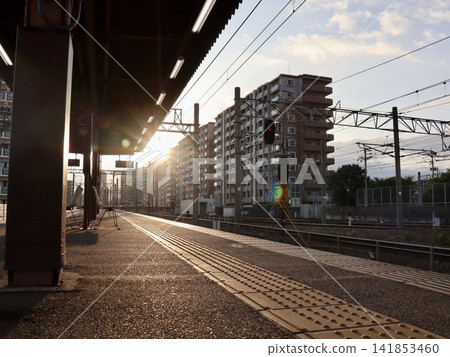 Early morning sunlight streaming onto a train station platform and a local railway scene (horizontal composition) | Web advertising material for travel, regional, railway, and transportation-related content Early morning sunlight streaming onto a train station platform and a local railway scene (horizontal composition) | Web advertising material for travel, regional, railway, and transportation-related content 141853460