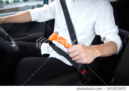 Japanese man with car emergency escape hammer and seatbelt cutter Japanese man with car emergency escape hammer and seatbelt cutter 141853635