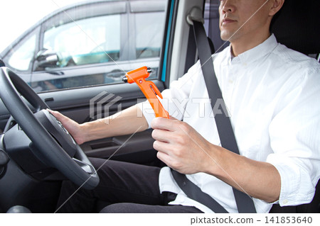 Japanese man with car emergency escape hammer and seatbelt cutter Japanese man with car emergency escape hammer and seatbelt cutter 141853640