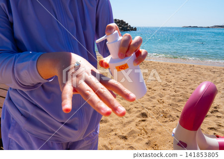 SPF, hands and girl on beach, sand and skincare for summer holiday in Korea SPF, hands and girl on beach, sand and skincare for summer holiday in Korea 141853805