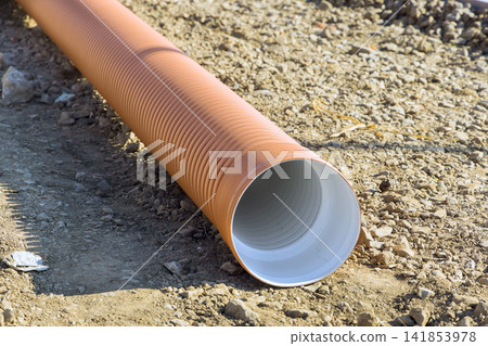 Construction site long pipe on ground in rural area Construction site long pipe on ground in rural area 141853978