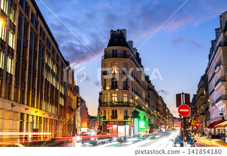 Parisian street and Haussmann architecture illuminated at dusk Parisian street and Haussmann architecture illuminated at dusk 141854180