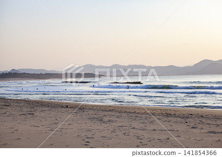 The sea at sunset and surfers The sea at sunset and surfers 141854366