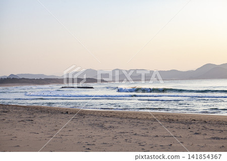 The sea at sunset and surfers The sea at sunset and surfers 141854367