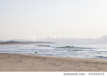 The sea at sunset and surfers The sea at sunset and surfers 141854372