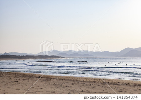 The sea at sunset and surfers The sea at sunset and surfers 141854374