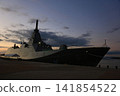 Destroyer in the harbor at dawn 141854522