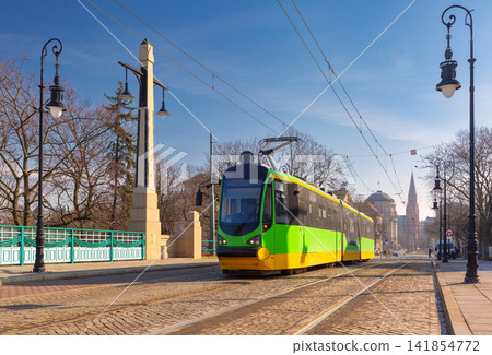 Modern Tram Crossing Historic Bridge in Poznan Poland Modern Tram Crossing Historic Bridge in Poznan Poland 141854772