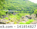Wide View Hida train crossing the railway bridge over the Jade Gorge 141854827