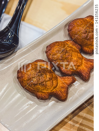 Crispy Japanese Taiyaki Fish Shaped Cakes Served on Plate in Restaurant Crispy Japanese Taiyaki Fish Shaped Cakes Served on Plate in Restaurant 141856235