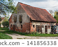 Old brick house with weathered facade in Gvardeysk, Russia 141856338