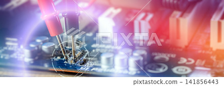 Electronic diagnostics banner. Multimeter probes testing a computer motherboard with digital HUD target overlay and bright light flares. Electronic diagnostics banner. Multimeter probes testing a computer motherboard with digital HUD target overlay and bright light flares. 141856443
