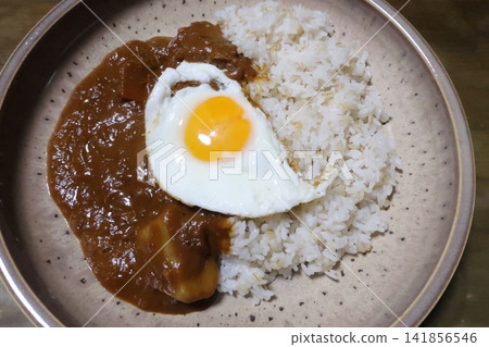 Curry rice topped with a fried egg Curry rice topped with a fried egg 141856546