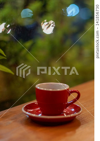 Black coffee in ceramic cup and saucer with blurred cafe lights Black coffee in ceramic cup and saucer with blurred cafe lights 141856730