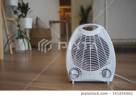 Home heater in living room on wooden floor Home heater in living room on wooden floor 141856902