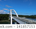 The magnificent Kesennuma Oshima Bridge shines brightly in the clear blue sky. 141857153