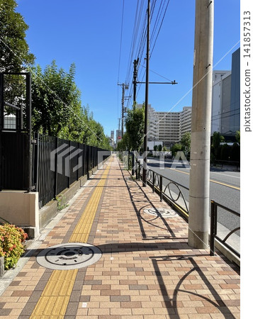 A straight sidewalk and blue sky 2 A straight sidewalk and blue sky 2 141857313