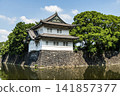 The moat's calm surface reflected the old Sakurada Tatsumi Yagura and stone walls, one of the Three Surviving Watchtowers of Edo Castle, in Tokyo Imperial Palace, Chiyoda, Japan. 141857377