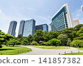 Path view of the Hama-rikyu Gardens and high-rise buildings near Shiodome in Chuo City, Tokyo, Japan. It was formerly the Tokugawa family's villa in the 17th century. 141857382