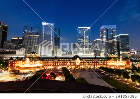Night view of Tokyo Station. It's a major inter-city rail terminal in Chiyoda, Tokyo, Japan, with the Marunouchi and Yaesu high-rise business buildings in view. Night view of Tokyo Station. It's a major inter-city rail terminal in Chiyoda, Tokyo, Japan, with the Marunouchi and Yaesu high-rise business buildings in view. 141857386