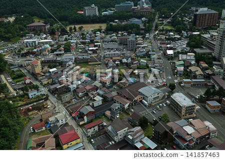An aerial photograph taken on a summer evening, showing a diagonal view of the town of Kusatsu in Gunma Prefecture. An aerial photograph taken on a summer evening, showing a diagonal view of the town of Kusatsu in Gunma Prefecture. 141857463